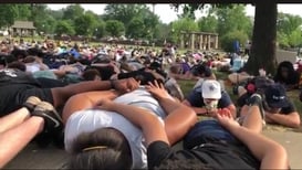 Image of protestors lying on the ground face down